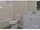 Well-lit bathroom featuring a toilet, vanity with sink, and shower with tub at 602 Still St # 1 Blk C, Chester, SC 29706
