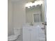 Modern bathroom with a white vanity, toilet, stylish mirror and lighting fixtures with neutral walls at 602 Still St # 1 Blk C, Chester, SC 29706