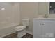 Well-lit bathroom featuring a toilet, vanity with sink, and shower with tub at 602 Still St # 1 Blk C, Chester, SC 29706
