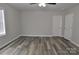 Comfortable bedroom featuring wood-look flooring, neutral walls and doors, and a bright window at 602 Still St # 1 Blk C, Chester, SC 29706