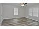 Bright bedroom featuring wood-look flooring, neutral walls, and abundant natural light from windows at 602 Still St # 1 Blk C, Chester, SC 29706