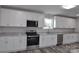 Modern kitchen with stainless steel appliances, white cabinets and beautiful granite countertops at 602 Still St # 1 Blk C, Chester, SC 29706