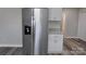 Kitchen featuring a stainless steel refrigerator, granite countertops, and white cabinetry at 602 Still St # 1 Blk C, Chester, SC 29706