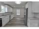 Spacious kitchen with stainless steel appliances, granite countertops, and modern wood-look flooring at 602 Still St # 1 Blk C, Chester, SC 29706
