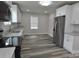 Bright kitchen with granite counters, stainless steel refrigerator, and wood-look floors at 602 Still St # 1 Blk C, Chester, SC 29706