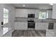 Bright kitchen featuring granite counters, stainless appliances, and ample white cabinetry at 602 Still St # 1 Blk C, Chester, SC 29706