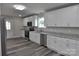 Well-lit kitchen featuring granite counters, stainless appliances, and white cabinetry at 602 Still St # 1 Blk C, Chester, SC 29706