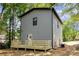 The back of this home features a wooden deck and siding in neutral colors at 620 Palmer Sw Ave, Concord, NC 28027