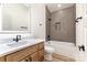 A modern bathroom featuring a vanity with a white countertop, and a shower-tub combo with hexagon tile surround at 620 Palmer Sw Ave, Concord, NC 28027