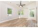 Bedroom with multiple windows, high ceilings, wood floors, and modern ceiling fan at 620 Palmer Sw Ave, Concord, NC 28027