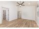 Bedroom with wood floors, bright walls, a modern ceiling fan, and multiple doorways at 620 Palmer Sw Ave, Concord, NC 28027