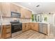 Modern kitchen featuring stainless steel appliances, bright countertops, and wood cabinets at 620 Palmer Sw Ave, Concord, NC 28027