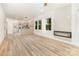 Open-concept floor plan with a fireplace, wood floors, and views of the kitchen at 620 Palmer Sw Ave, Concord, NC 28027