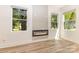 Bright living room featuring wood floors, a modern fireplace, and large windows for natural light at 620 Palmer Sw Ave, Concord, NC 28027
