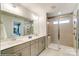 Bathroom with dual sinks and a glass door shower at 6266 Tea Olive Dr # 238, Harrisburg, NC 28075