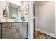 Modern half-bathroom features a gray vanity with storage, a mirror, and neutral paint at 6266 Tea Olive Dr # 238, Harrisburg, NC 28075