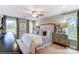 Bright main bedroom features large windows with neutral decor, a ceiling fan, and carpet at 6266 Tea Olive Dr # 238, Harrisburg, NC 28075