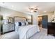Main bedroom with many windows, neutral decor, a ceiling fan, and carpet at 6266 Tea Olive Dr # 238, Harrisburg, NC 28075