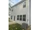 View of the home's exterior, featuring vinyl siding and a back door leading to a small yard at 631 S Elm St, Statesville, NC 28677