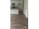 Modern kitchen featuring stainless steel appliances, an island, and hardwood style flooring at 631 S Elm St, Statesville, NC 28677