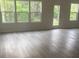 Bright open-concept living area featuring abundant natural light, hardwood style flooring, and neutral paint at 631 S Elm St, Statesville, NC 28677