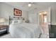Bedroom featuring a queen bed, a closet, and a bedside table at 6842 Berewick Commons Pkwy, Charlotte, NC 28278