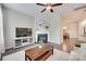 Comfortable living room with fireplace leading to a dining area at 6842 Berewick Commons Pkwy, Charlotte, NC 28278