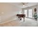 Cozy room showcasing a piano, ceiling fan, and double doors to an outdoor space at 6842 Berewick Commons Pkwy, Charlotte, NC 28278