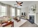 Cozy living room with a fireplace, ceiling fan, and natural light at 6842 Berewick Commons Pkwy, Charlotte, NC 28278