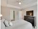 The main bedroom boasts a tray ceiling, ceiling fan, and a large TV at 6842 Berewick Commons Pkwy, Charlotte, NC 28278