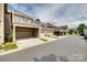 Street view of townhouses with garages and balconies offering modern living at 6842 Berewick Commons Pkwy, Charlotte, NC 28278