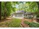 Expansive backyard features a patio, mature trees, and landscaped grounds at 6868 St Peters Ln, Matthews, NC 28105