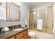 Well-lit bathroom featuring granite counters, a glass door shower, and classic finishes at 6868 St Peters Ln, Matthews, NC 28105