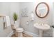 Stylish powder room featuring elegant fixtures and a decorative mirror at 6868 St Peters Ln, Matthews, NC 28105