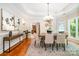 Elegant dining room with hardwood floors, designer chandelier, and tranquil view at 6868 St Peters Ln, Matthews, NC 28105
