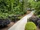 Long driveway leads through lush landscaping to the stately home at 6868 St Peters Ln, Matthews, NC 28105