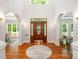 Grand foyer boasts hardwood floors, arched openings, and a custom leaded glass front door at 6868 St Peters Ln, Matthews, NC 28105