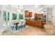 Eat-in kitchen with beautiful cabinetry, large windows with views, and tile floors at 6868 St Peters Ln, Matthews, NC 28105