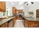 Well-lit kitchen featuring stainless steel appliances, stylish counters, and sleek cabinets at 6868 St Peters Ln, Matthews, NC 28105