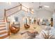 Expansive living room featuring a staircase, fireplace, skylights, and comfortable seating at 6868 St Peters Ln, Matthews, NC 28105