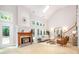 Bright living room with a cozy fireplace, skylight, and access to outdoor area at 6868 St Peters Ln, Matthews, NC 28105