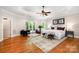 Bright main bedroom featuring hardwood floors, sitting area, and ensuite bathroom at 6868 St Peters Ln, Matthews, NC 28105
