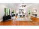 Spacious main bedroom featuring tray ceilings, seating area, and large windows with wooded views at 6868 St Peters Ln, Matthews, NC 28105