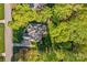 Overhead view of a private home surrounded by verdant trees and manicured lawns at 7896 Harbor Master Ct, Denver, NC 28037
