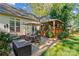 Inviting back patio with outdoor dining set, umbrella, and a covered porch, perfect for entertaining and relaxation at 7896 Harbor Master Ct, Denver, NC 28037