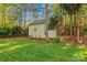 Spacious backyard with lush green lawn, mature trees, and a charming shed, offering ample space for outdoor activities at 7896 Harbor Master Ct, Denver, NC 28037