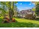 Spacious backyard featuring a deck, patio with furniture, and lush garden at 7896 Harbor Master Ct, Denver, NC 28037