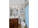 Well-lit bathroom with a modern vanity, decorative mirror and bright blue shower curtain at 7896 Harbor Master Ct, Denver, NC 28037