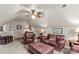 A large bonus room with a ceiling fan, lots of comfortable seating and a cool vintage-style steamer trunk for storage at 7896 Harbor Master Ct, Denver, NC 28037