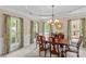 Formal dining room featuring elegant chandelier, and large windows with floral curtains at 7896 Harbor Master Ct, Denver, NC 28037